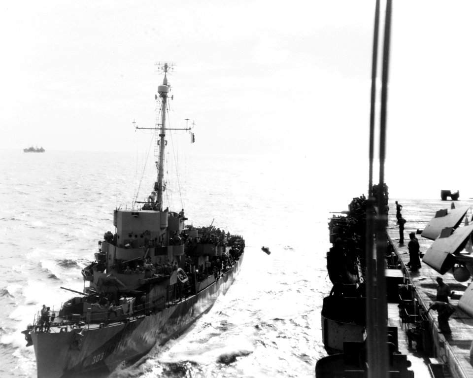 USS Crowley (DE-303) transfers crewman to USS Sargent Bay (CVE-83), 15 January 1945 (80-G-263957)