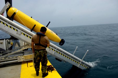 US Navy 070612-N-7676W-102 Chief Aerographer's Mate Trung Freed, from Naval Mine and Anti-Submarine Warfare Command, Corpus Christi, Texas, monitors the deployment of a Bluefin Autonomous Underwater Vehicle (AUV) during a