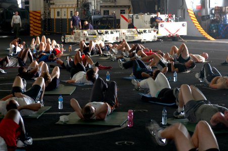 US Navy 070611-N-9760Z-024 Sailors and Marines exercise during command physical training in the hangar bay of nuclear-powered aircraft carrier USS Nimitz (CVN 68)