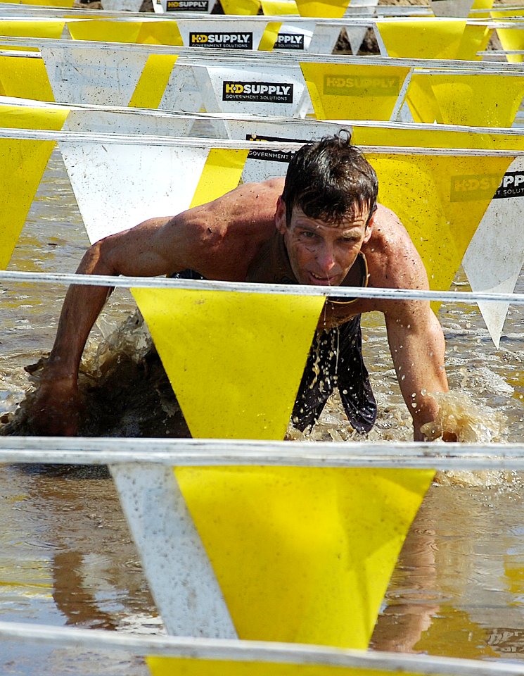 US Navy 070610-N-4163T-035 Runners crawl through the final obstacle of the 14th Annual World Famous Mud Run