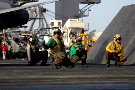 US Navy 070618-N-7128A-041 Aviation Boatswain's Mate (Equipment) 1st Class Juan Salcedo signals the shooter after the catapult's final check that a jet is clear to launch during flight operations aboard nuclear-powered aircraft