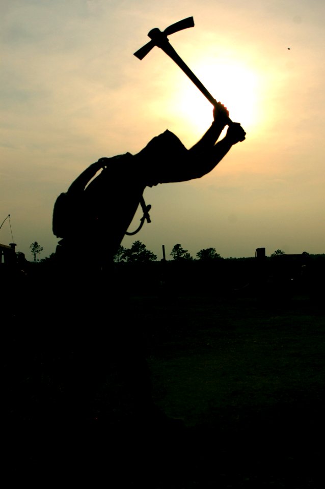 US Navy 070614-N-7367K-005 Steelworker 3rd Class James Branstietter, a Seabee attached to Naval Mobile Construction Battalion (NMCB) 1, digs a trench for WD-1 wire