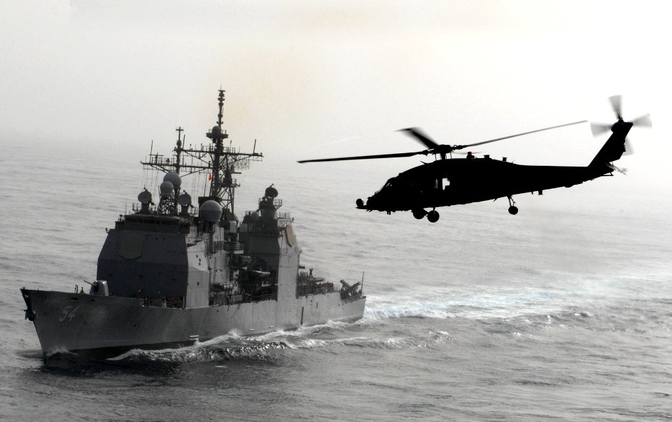 US Navy 070616-N-3038W-036 An HH-60H assigned to the Eightballers of Helicopter Anti-Submarine Squadron (HS) 8 flies near USS Antietam (CG) 54 after off loading cargo onto the flight deck of the Nimitz-class aircraft carrier US