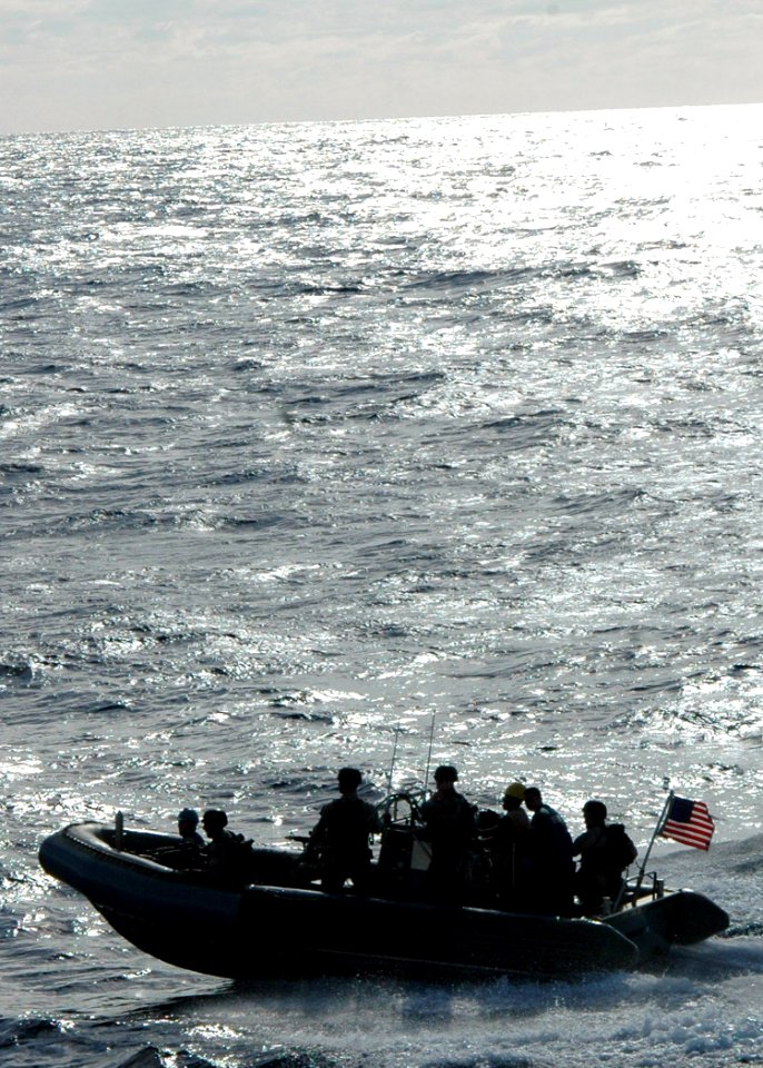 US Navy 070616-N-6710M-025 Members assigned to the visit, board, search and seizure (VBSS) team on board guided-missile destroyer USS Paul Hamilton (DDG 60) prepare to board dock landing ship USS Tortuga (LSD 46) during a train