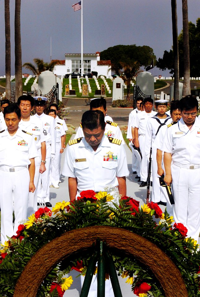 US Navy 070613-N-4163T-015 Captain Takanari Murata, commander, Escort Division 4 Japan Maritime Self-Defense Force (JMSDF), bows his head along with other Japanese Sailors during a wreath-laying ceremony at Fort Rosecrans Natio