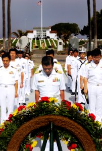 US Navy 070613-N-4163T-015 Captain Takanari Murata, commander, Escort Division 4 Japan Maritime Self-Defense Force (JMSDF), bows his head along with other Japanese Sailors during a wreath-laying ceremony at Fort Rosecrans Natio photo