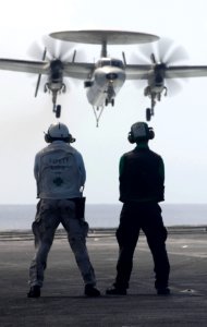 US Navy 070620-N-3729H-091 Flight deck crew members watch an E-2C Hawkeye, from the