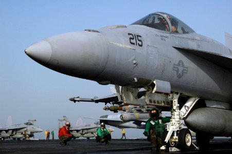 US Navy 070618-N-7128A-046 Aviation Boatswain's Mate (Equipment) 3rd Class Michael Selvey makes sure an F-A-18E Super Hornet is correctly attached to the catapult shuttle prior to launching from nuclear-powered aircraft carrier