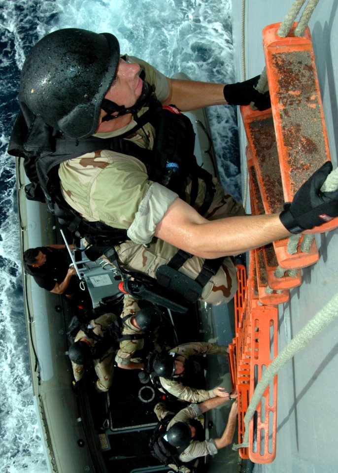 US Navy 070616-N-6710M-043 Members assigned to the visit, board, search and seizure (VBSS) team on board guided-missile destroyer USS Paul Hamilton (DDG 60) board dock landing ship USS Tortuga (LSD 46) during a training scenari