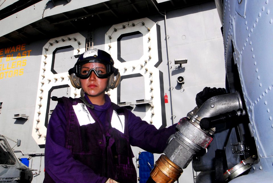 US Navy 070614-N-6326B-058 Aviation Boatswain's Mate (Fuel) Airman Raynelle Brown attaches a fuel nozzle to an SH-60F Seahawk helicopter aboard nuclear-powered aircraft carrier USS Nimitz (CVN 68)