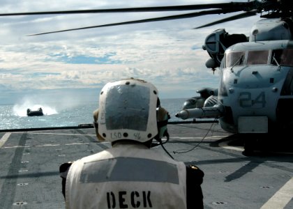 US Navy 070620-N-6710M-031 A landing craft air cushion (LCAC) prepares to enter the well deck while awaiting the departure of a CH-53 Sea Stallion on the flight deck of dock landing ship USS Tortuga (LSD 46) while conducting Ta photo