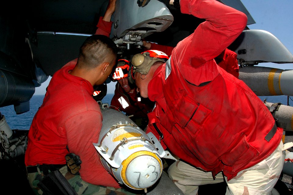 US Navy 070614-N-9760Z-024 Aviation ordnancemen load a GBU-38 JDAM bomb on an F-A-18C Hornet, assigned to the Sunliners of Strike Fighter Squadron (VFA) 81, aboard nuclear-powered aircraft carrier USS Nimitz (CVN 68)