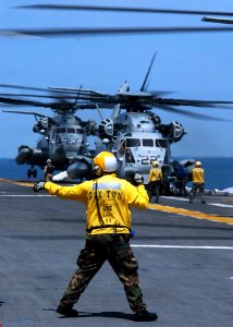 US Navy 070615-N-4014G-231 A Sailor aboard amphibious assault ship USS Kearsarge (LHD 3) directs a CH-53E Super Stallion assigned to Marine Medium Helicopter Squadron (HMM) 261