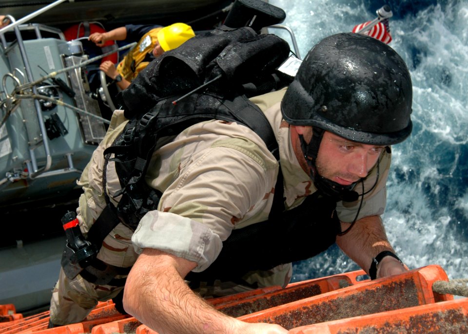 US Navy 070616-N-6710M-047 Members assigned to the visit, board, search and seizure (VBSS) team on board guided-missile destroyer USS Paul Hamilton (DDG 60) board dock landing ship USS Tortuga (LSD 46) during a training scenari