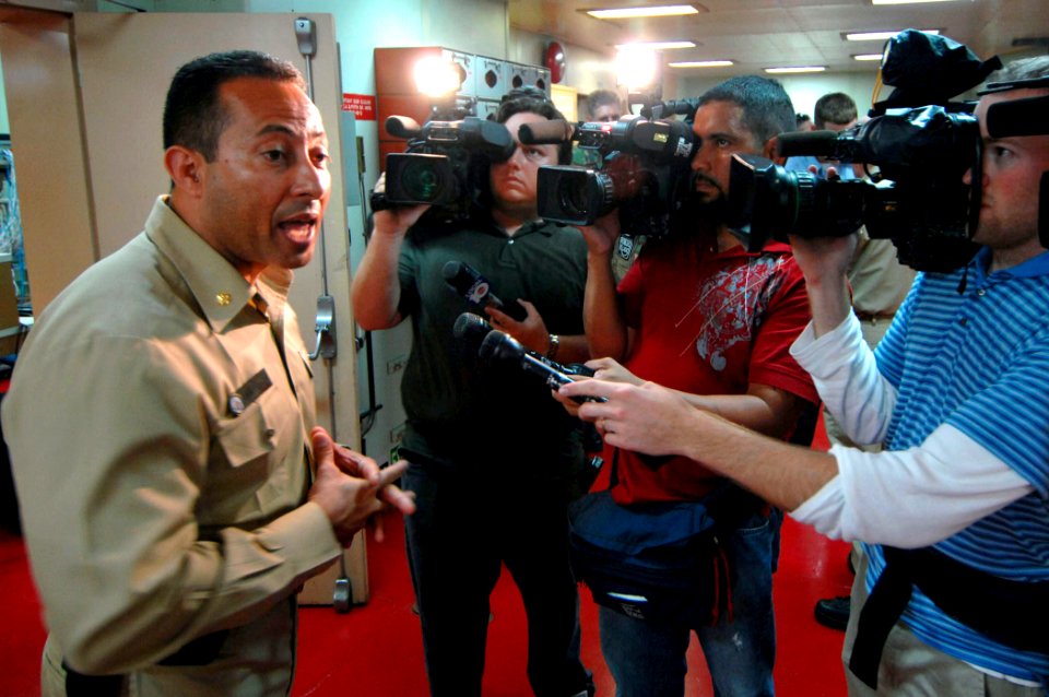 US Navy 070617-N-0194K-293 Casualty and Receiving Division Officer Lt. Cmdr. Manny Santiago addresses Miami media aboard Military Sealift Command hospital ship USNS Comfort (T-AH 20)