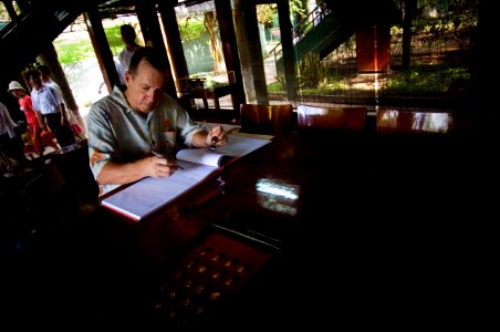 US Navy 070620-N-0696M-049 Chief of Naval Operations (CNO) Adm. Mike Mullen signs a guest book after touring a cottage used by Vietnamese President Ho Chi Minh