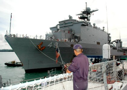 US Navy 070618-N-7783B-002 A member of the Royal Thai Navy looks on as the dock landing ship USS Harpers Ferry (LSD 49) arrives in port for the Thailand phase of the exercise Cooperation Afloat Readiness and Training (CARAT) 20