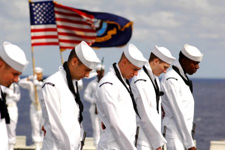 US Navy 070618-N-5387K-025 USS Kitty Hawk (CV 63) Honor Guard bow their heads during a burial at sea ceremony