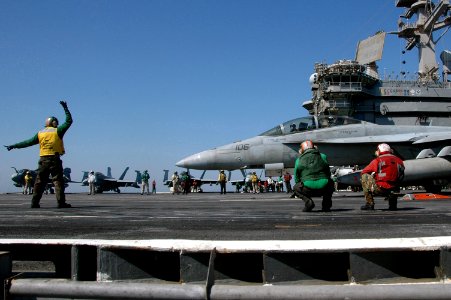 US Navy 070620-N-0890S-044 Aviation Boatswain's Mate (Equipment) 1st Class Juan Salcido, signals the pilot prior to launch of an F-A-18F Super Hornet