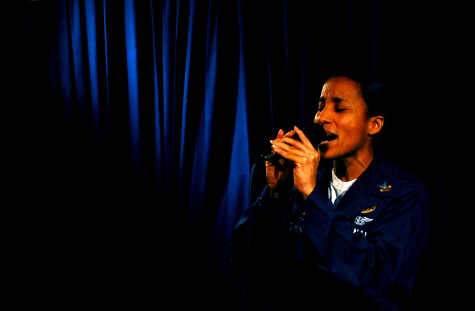 US Navy 070620-N-0684R-027 Navy Counselor 1st Class Cynthia Vaughn, assigned to the Eightballers of Helicopter Anti-Submarine Squadron (HS) 8, sings a song during the Stennis Idol singing competition