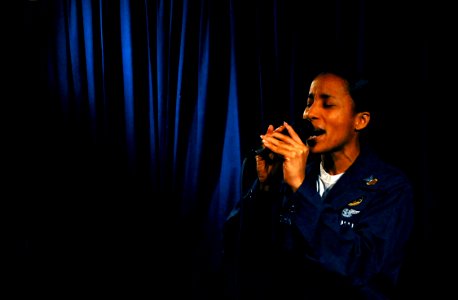 US Navy 070620-N-0684R-027 Navy Counselor 1st Class Cynthia Vaughn, assigned to the Eightballers of Helicopter Anti-Submarine Squadron (HS) 8, sings a song during the Stennis Idol singing competition