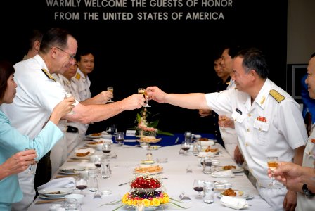 US Navy 070620-N-0696M-483 Chief of Naval Operations (CNO) Adm. Mike Mullen toasts at a dinner hosted by Vietnamese People's Navy Vice Adm. Pham Ncoc Phin during a visit to Hai Phong, Vietnam