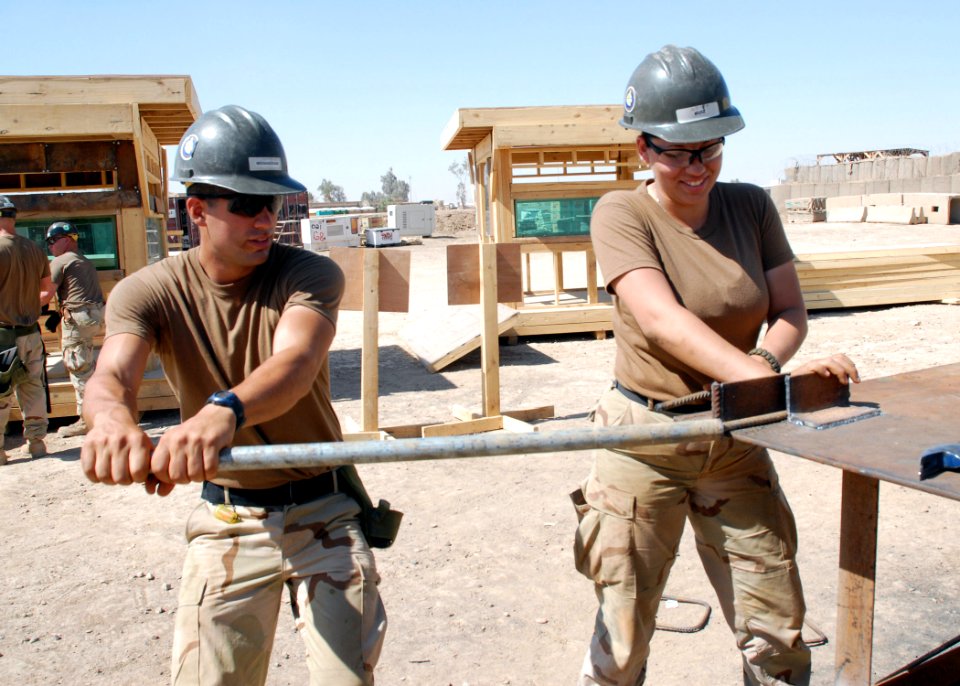 US Navy 070620-N-3560G-054 Steelworker Constructionman Siamac Moghaddam and Builder Constructionman Teresa Ruiz, of Naval Mobile Construction Battalion (NMCB) 4, shape steel supports to be used on various construction projects