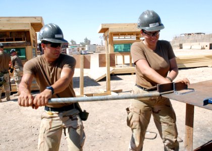 US Navy 070620-N-3560G-054 Steelworker Constructionman Siamac Moghaddam and Builder Constructionman Teresa Ruiz, of Naval Mobile Construction Battalion (NMCB) 4, shape steel supports to be used on various construction projects
