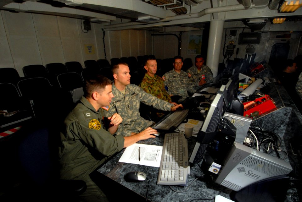 US Navy 070622-N-4790M-029 Members of a joint U.S.-Australian civil affairs team discuss the logistics of a Red Cross contingent delivering supplies and humanitarian aid to a simulated refugee camp
