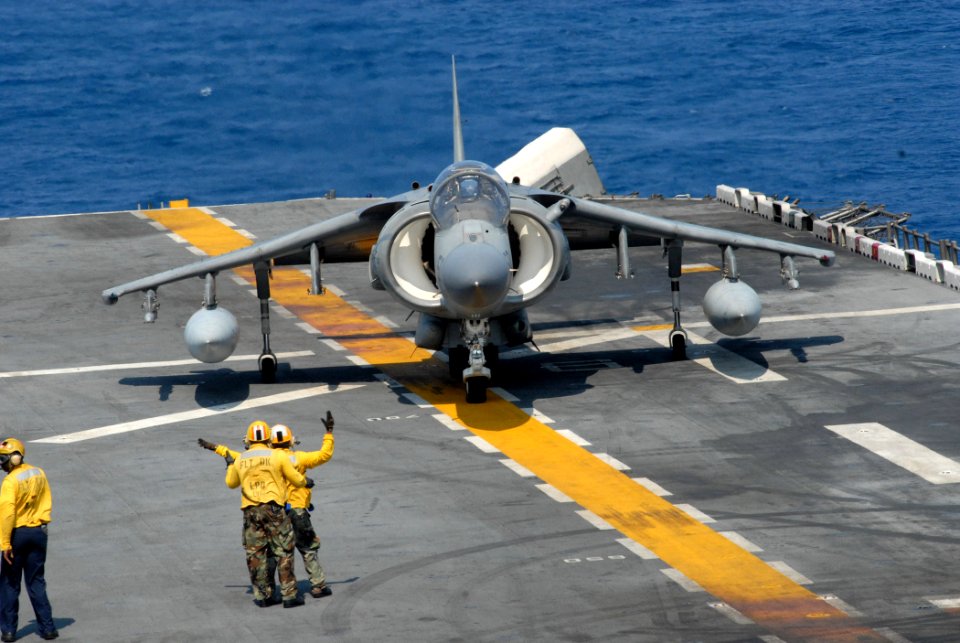 US Navy 070617-N-5033P-113 Aviation boatswain's mates aboard amphibious assault ship USS Kearsarge (LHD 3) direct an A-V-8B Harrier in preparation to take off during flight operations