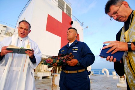 US Navy 070619-N-6081J-014 Lt. Cmdr. Paul Evers, a Navy chaplain aboard the Military Sealift Command hospital ship USNS Comfort (T-AH 20), recites memorial rites for Robert Lee Royer photo