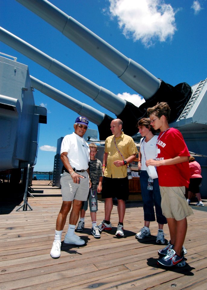 US Navy 070619-N-9758L-114 Nathaniel Allen, along with his family, learn about the wood deck of USS Missouri (BB 63) during a private tour sponsored by the Make-A-Wish foundation