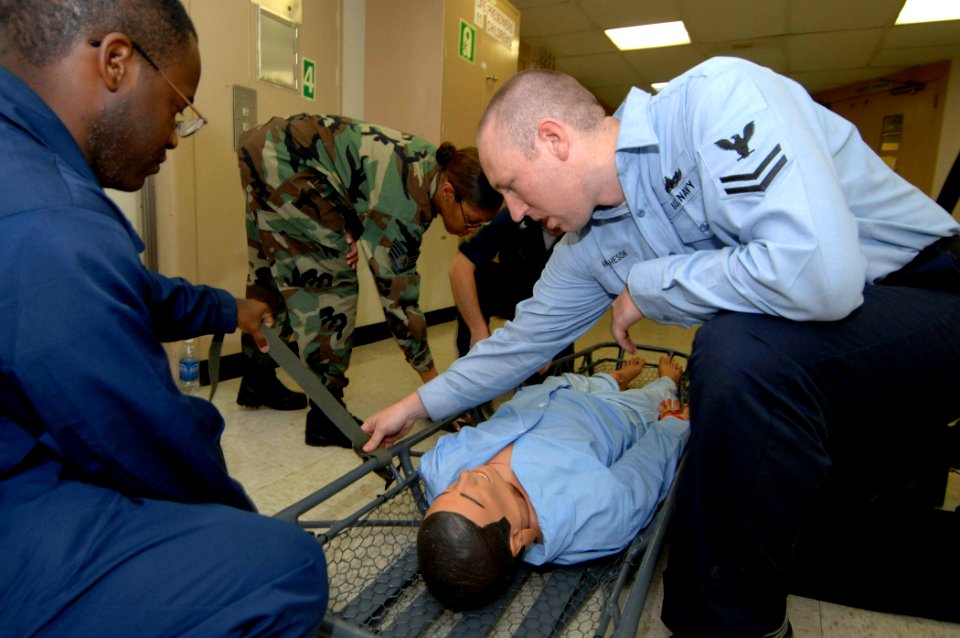 US Navy 070621-N-0194K-003 Hospital Corpsman 2nd Class Samuel Hutcheson conducts stretcher bearer training aboard Military Sealift Command hospital ship USNS Comfort (T-AH 20) photo