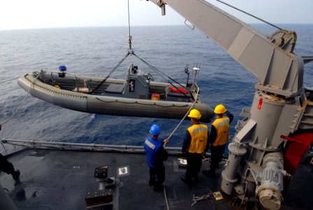 US Navy 070623-N-0841E-043 Sailors on board guided-missile cruiser USS Vicksburg (CG 69) lower a rigid hull inflatable boat (RHIB) into the water before taking part in a boarding scenario training exercise