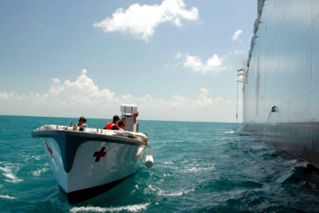 US Navy 070620-N-8704K-023 Civilian mariners operate a lifeboat used to transport crew and patients from Military Sealift Command hospital ship USNS Comfort (T-AH 20) to Belize City, Belize