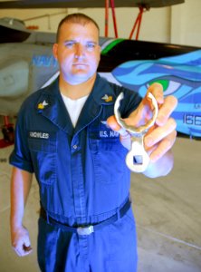 US Navy 070619-N-4774B-003 Aviation Structural Mechanic 1st Class Trevor Knowles displays the oil line wrench he invented