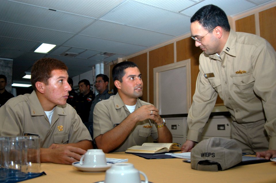 US Navy 070618-N-7029R-153 Lt. Michael Gruell, weapons officer from USS Mitscher (DDG 57) and Peruvian officers have a discussion during an opening conference of UNITAS 48-07 Pacific phase