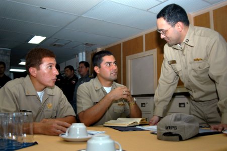 US Navy 070618-N-7029R-153 Lt. Michael Gruell, weapons officer from USS Mitscher (DDG 57) and Peruvian officers have a discussion during an opening conference of UNITAS 48-07 Pacific phase