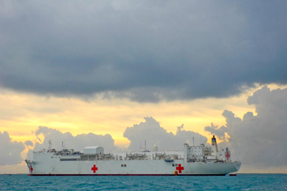 US Navy 070622-N-0194K-023 The sun rises behind the Military Sealift Command hospital ship USNS Comfort (T-AH 20), anchored several miles off the coast of Belize