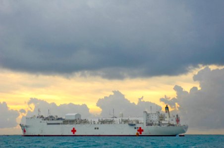 US Navy 070622-N-0194K-023 The sun rises behind the Military Sealift Command hospital ship USNS Comfort (T-AH 20), anchored several miles off the coast of Belize photo