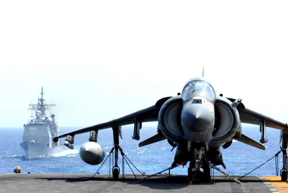 US Navy 070620-N-5033P-125 An A-V-8B Harrier rests on the flight deck of amphibious assault ship USS Kearsarge (LHD 3) as guided missile cruiser USS Vicksburg (CG 69) approaches