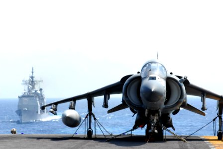 US Navy 070620-N-5033P-125 An A-V-8B Harrier rests on the flight deck of amphibious assault ship USS Kearsarge (LHD 3) as guided missile cruiser USS Vicksburg (CG 69) approaches