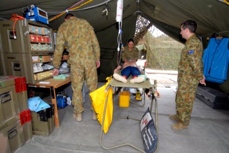 US Navy 070620-N-4965F-012 Medics assigned to the Australian Defense Force, 1st Health Support Battalion, simulate treatment for a gunshot wound at the field hospital in the Shoalwater Bay Training Area