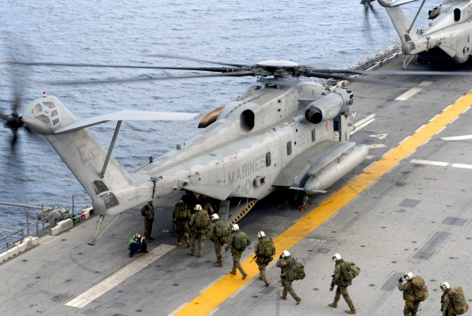 US Navy 070619-N-4010S-032 Marines assigned to 3rd Marine Expeditionary Brigade prepare to load into a CH-53E Super Stallion, attached to the Marine Medium Helicopter Squadron (HMM) 265