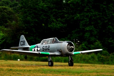 US Navy 070620-N-1688B-121 During an air show to commemorate the World War II Battle of Midway, a 1949 North American T-6G aircraft lands on the grass airfield, at the Virginia Beach Airport