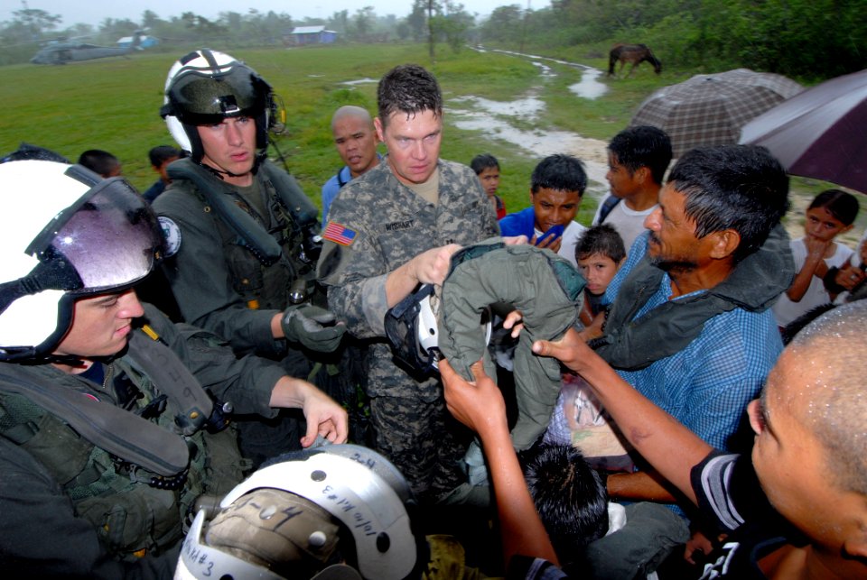US Navy 070623-N-8704K-162 U.S. Navy Aviation Systems Warfare Operators 3rd Class Eric Rockwell (left) and 2nd Class Trevor Ahrendt (middle) of Helicopter Anti Submarine Squadron 28, work with U.S. Army Capt. John Wishart to p