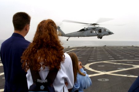 US Navy 070622-N-3925A-006 Friends and family members of Sailors aboard amphibious transport dock USS Cleveland (LPD 7) observe flight operations during a Friends and Family Day Cruise