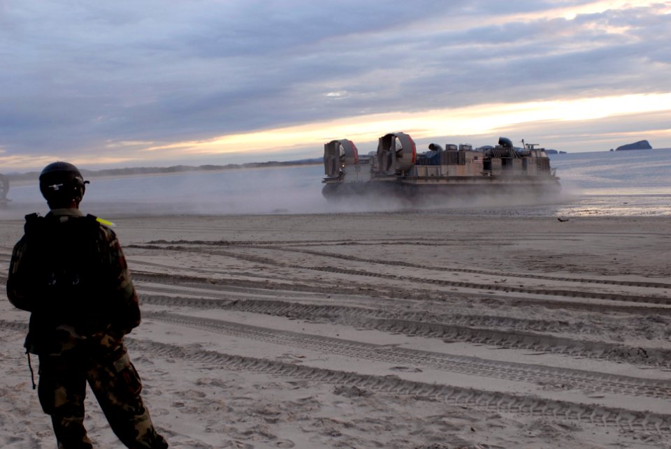 US Navy 070620-N-6936D-091 A member of Beach Master Unit (BMU) 1 watches as a landing craft air cushion (LCAC) departs the beach after dropping off Marine cargo at the start of the field training phase of Talisman Saber 2007 (T