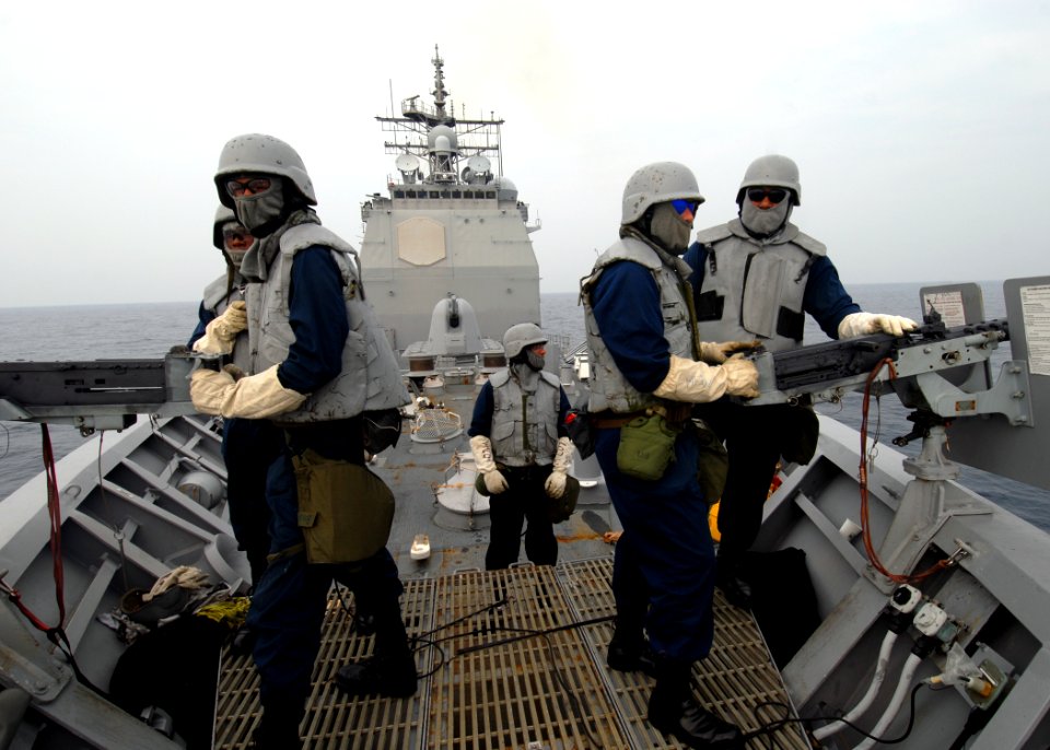 US Navy 070623-N-0841E-160 Sailors assigned to the small craft action team (SCAT) man the .50-caliber machine guns on board guided-missile cruiser USS Vicksburg (CG 69) before taking part in a boarding scenario training exercis