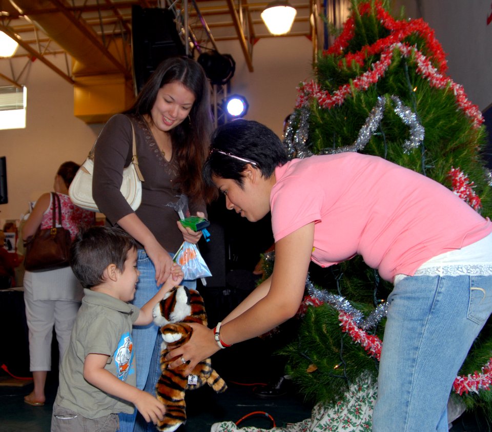 US Navy 070625-N-4995K-128 A Marine's son receives a stuffed tiger at the Christmas You Missed event at the Murphy Canyon Youth Center